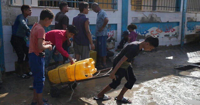 Palestinians collect clean drinking water at a desalination plant that now operates round the clock in Deir al-Balah, Gaza, Nov. 14, 2024. (AP/Abdel Kareem Hana)