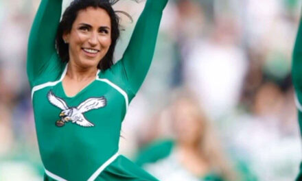 Pom-poms waving, a Philadelphia Eagles cheerleader leans into her Judaism