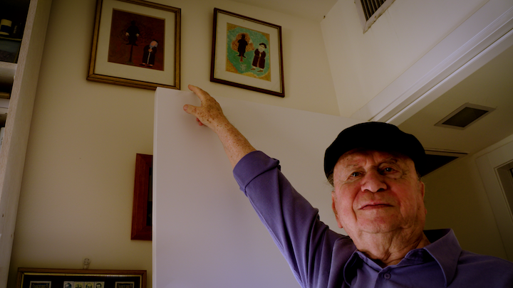 Among Neighbors_Yaacov Goldstein pointing to Jewish art painted by his great-uncle Among Neighbors_Yaacov Goldstein pointing to Jewish art painted by his great-uncle