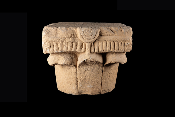 Ancient stone capital depicting a menorah on display
