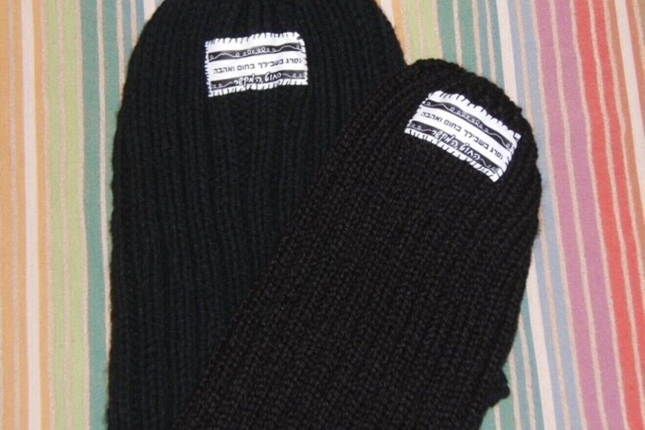Knitted black hats donated to soldiers in the Israel Defense Forces. Credit: Courtesy.