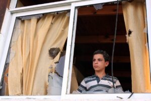 Looking out through the broken window of a house in the southern city of Sderot, hit by a Qassam rocket fired by terrorists in the Gaza Strip, May 19, 2009. Photo courtesy of Edi Israel/Flash90.
